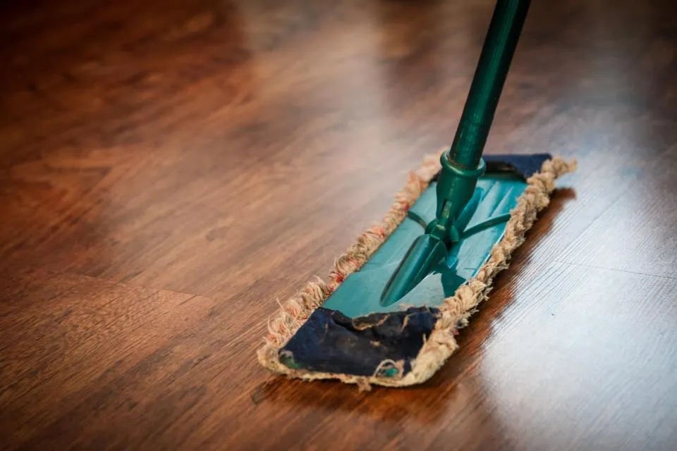 A flat mop cleaning a wooden floor